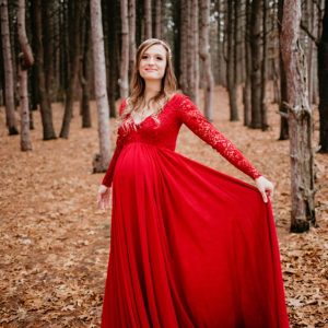 Bright red longsleeve maternity dress photoshoot in the woods